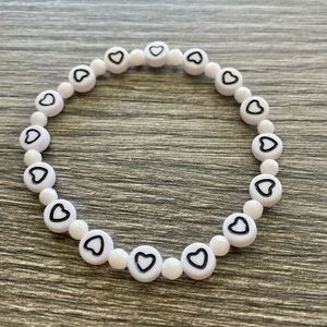 Black and white heart bracelet accented with faceted white jade.  One size